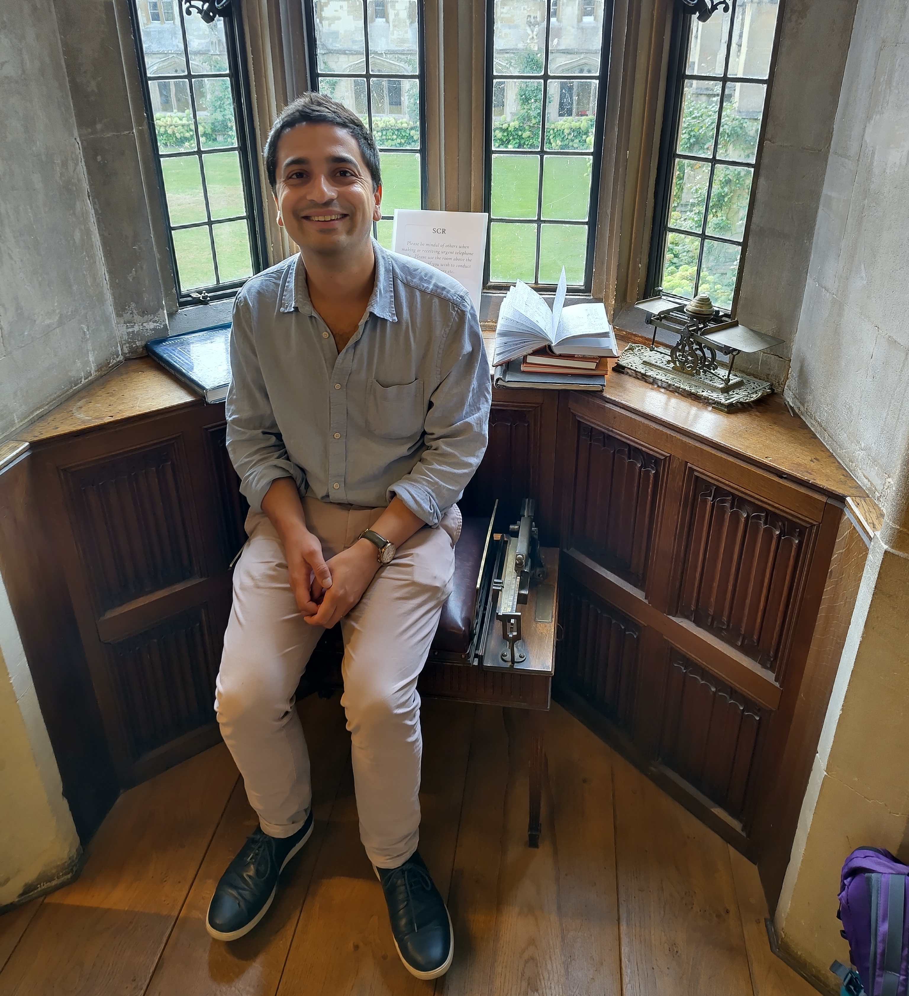 Photograph of me sat on an antique jockey scale.